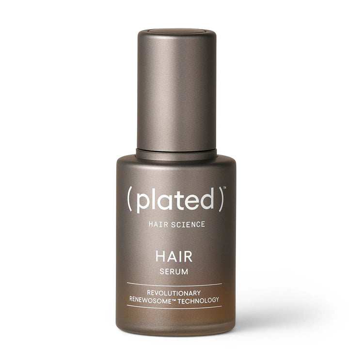 Plated hair serum bottle on a white background